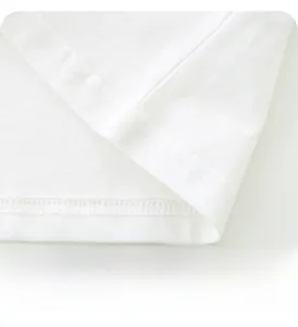 Detail of double-needle stitching on the hem of white cotton boys' t-shirt