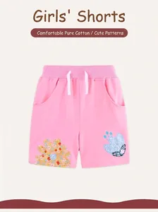 Detailed view of pink cotton girls' shorts featuring floral butterfly embroidery and drawstring
