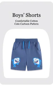 Close-up of boys' navy shorts showing drawstring waist and shark embroidery detail