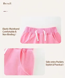 Detail view of pink cotton sports shorts with elastic waistband and side pockets