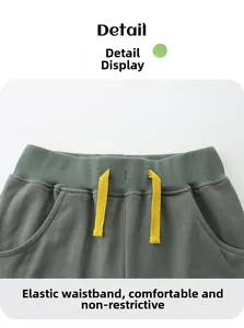 Detail of boys' shorts featuring elastic ribbed waistband and yellow drawstring
