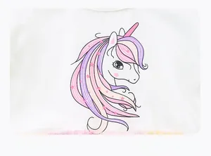 Close-up of cute unicorn and stars cartoon print on girls white summer dress