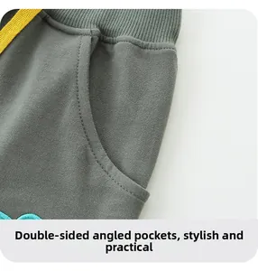 Detail of grey cotton shorts featuring contrast yellow drawstring and rib knit waistband