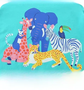 Close-up of mint green cotton kids t-shirt with colorful cartoon jungle animal prints