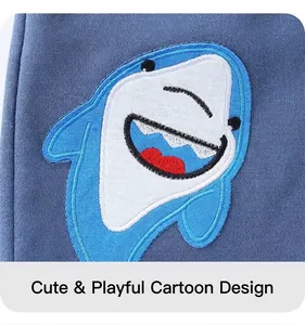 Detailed close-up of shark embroidery patch on navy blue knit shorts fabric