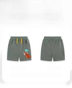 Detail of boys green cotton knit shorts featuring embroidered tiger patch and yellow drawstring