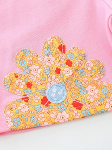Pink cotton girls top featuring a large yellow floral applique with fine stitching details