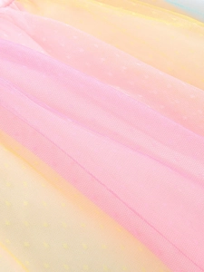 Close-up of rainbow gradient mesh fabric with subtle star print for girls' princess dress
