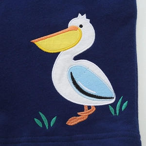 Navy blue boys cotton shorts featuring a colorful cartoon pelican embroidery detail
