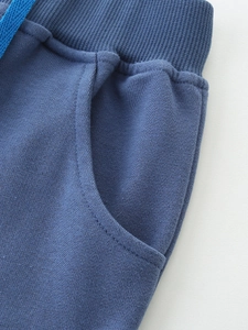 Boys navy blue cotton shorts with elastic waistband and bright blue drawstrings