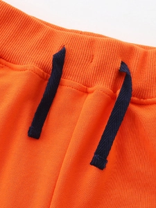 Boys bright orange sports shorts with elastic ribbed waistband and blue drawstring