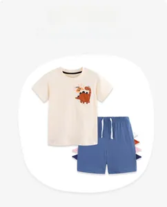 Detailed view of kids summer set with dinosaur print T-shirt and shorts with tail accents