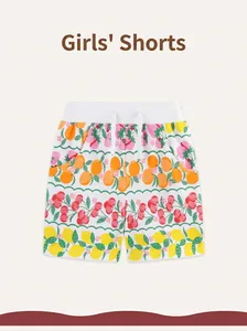 Detailed macro view of pure cotton fabric texture with colorful fruit prints for kids shorts