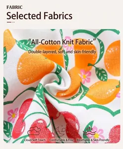 Close-up of soft knitted cotton fabric with vibrant orange and cherry citrus print