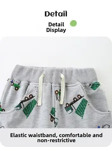 Detail of grey cotton shorts featuring elastic waistband with drawstring and truck print
