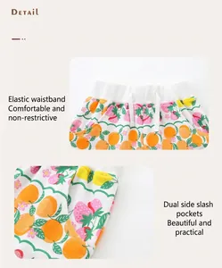 Detail of girls' summer cotton shorts featuring elastic waist and fruit print patterns