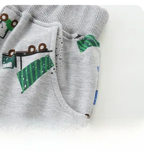Detail of grey cotton knit shorts with cartoon truck print and functional side pockets
