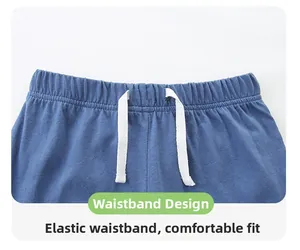 Detail of blue toddler shorts with elastic waistband and white functional drawstring