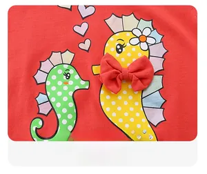 Close-up of cute seahorse prints with a 3D red fabric bow on red cotton children t-shirt