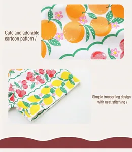 Detail of girls' cotton shorts showing fruit patterns and neat double stitching craft