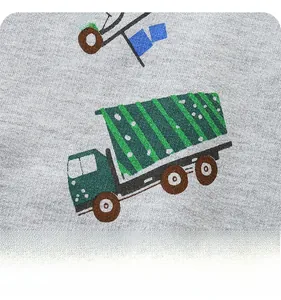 Detailed close-up of cartoon truck print on grey cotton knit fabric for boys' shorts