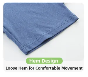 Detail of loose hem and double-needle stitching on blue cotton shorts for boys