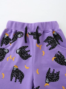 Kids purple joggers with cartoon gorilla and banana prints featuring an elastic waistband