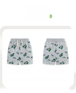 Front and back view of light gray knit cotton boy shorts with green dump truck prints