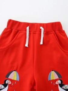 Girls red athletic shorts with white drawstring and colorful puffin embroidery