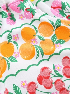 Girls' white cotton shorts with colorful fruit print and elastic ribbed waistband