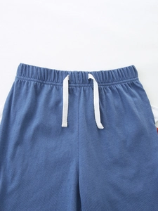 Kids navy blue dinosaur cotton shorts featuring elastic waistband and white drawstring