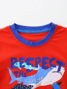 Kids red cotton T-shirt featuring a blue crew neck and cartoon shark print graphic