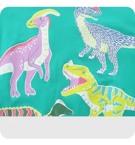 Close-up of soft green cotton fabric featuring vibrant cartoon dinosaur prints for kids