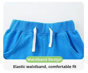 Detailed macro view of boys' blue cotton knit shorts with elastic waistband and white drawstrings