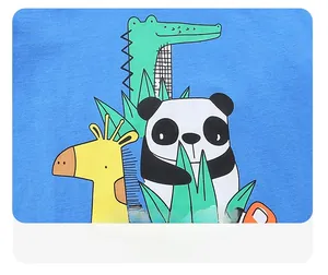 Detail of colorful cartoon crocodile and panda prints on blue cotton boys' t-shirt