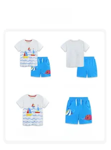 Front and back detail of boy's white cotton T-shirt with sailboat print and blue shorts