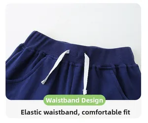 Detail of boys navy knit trousers with elastic ribbed waistband and white drawstrings