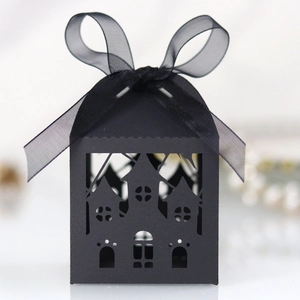 Detail of laser-cut black gothic castle candy box with a delicate organza ribbon bow