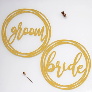 Golden glitter wedding chair signs with groom and bride cutout lettering for decor