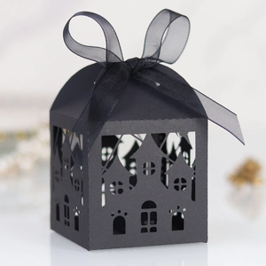 Detail of laser-cut black gothic castle candy box with elegant organza ribbon bow