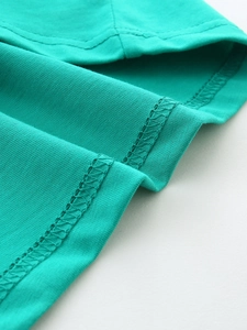 Glow-in-the-dark dinosaur t-shirt detail showing high-quality stitching and green fabric