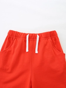 Kids sports cotton shorts in vibrant red with elastic waist and white drawstrings