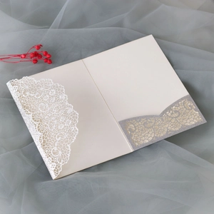 Close-up of laser-cut silver glitter lace wedding invitation with pocket detail