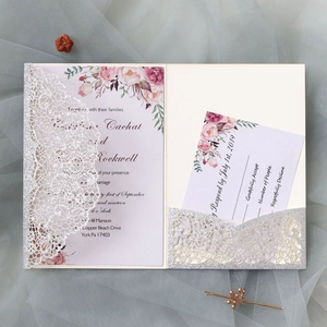Detailed laser-cut lace wedding invitation set with floral inner card and silver glitter