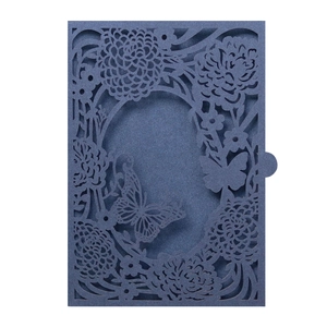 Detail of laser-cut butterfly and floral patterns on navy blue pearl paper envelope