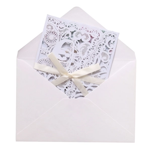 Detailed laser-cut wedding invitation featuring elegant white horse carriage and floral motifs