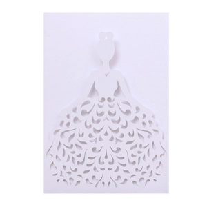 Intricate laser-cut floral patterns on the skirt of a white paper wedding invitation card