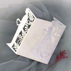 Λεπτομέρεια προσκλητηρίου γάμου laser-cut με γκλίτερ καρδιές και σιλουέτες ζευγαριού