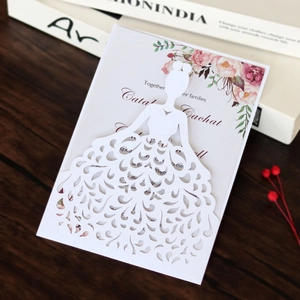 Detail of laser-cut wedding invitation featuring a floral bride silhouette and pink roses