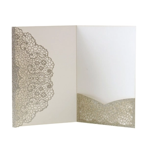 Detail of champagne gold glitter wedding invitation with laser cut lace hollow pattern